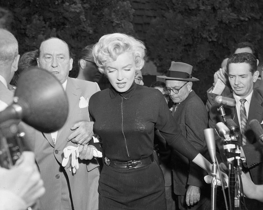 Monroe outside her home with lawyer Jerry Giesler, who later that day would announce that Monroe's marriage to Joe DiMaggio was ending.