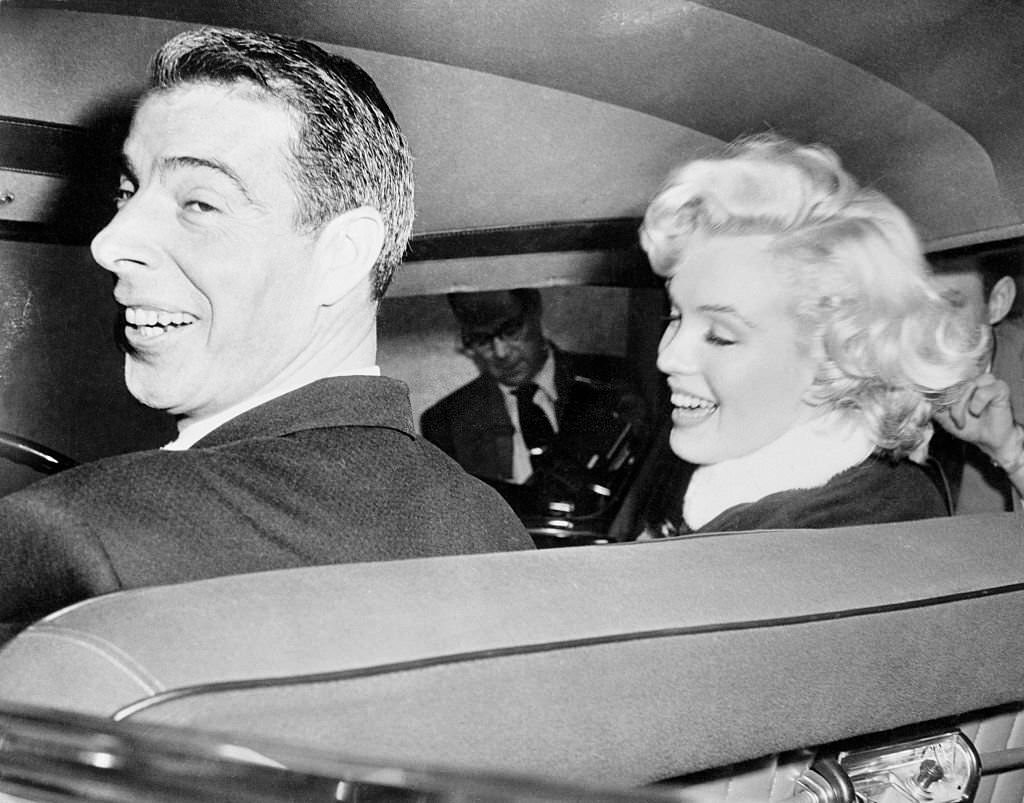 Joe DiMaggio and his Bride Marilyn Monroe as they prepare to leave by car on their honeymoon.