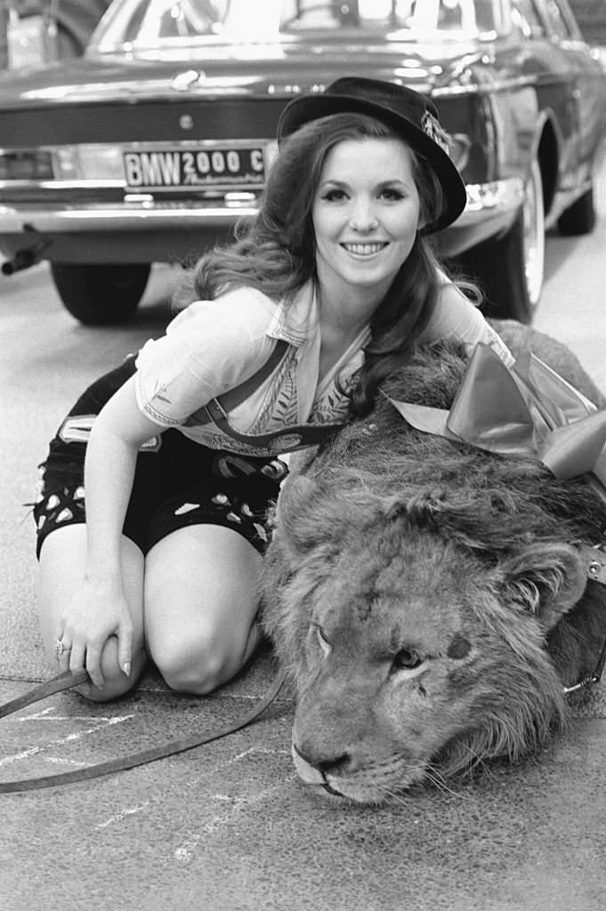 Statuesque model Nell Theobald poses April 8 with Ludwig, a lion, during a promotion session inside the New York Coliseum for an automobile manufacturer.