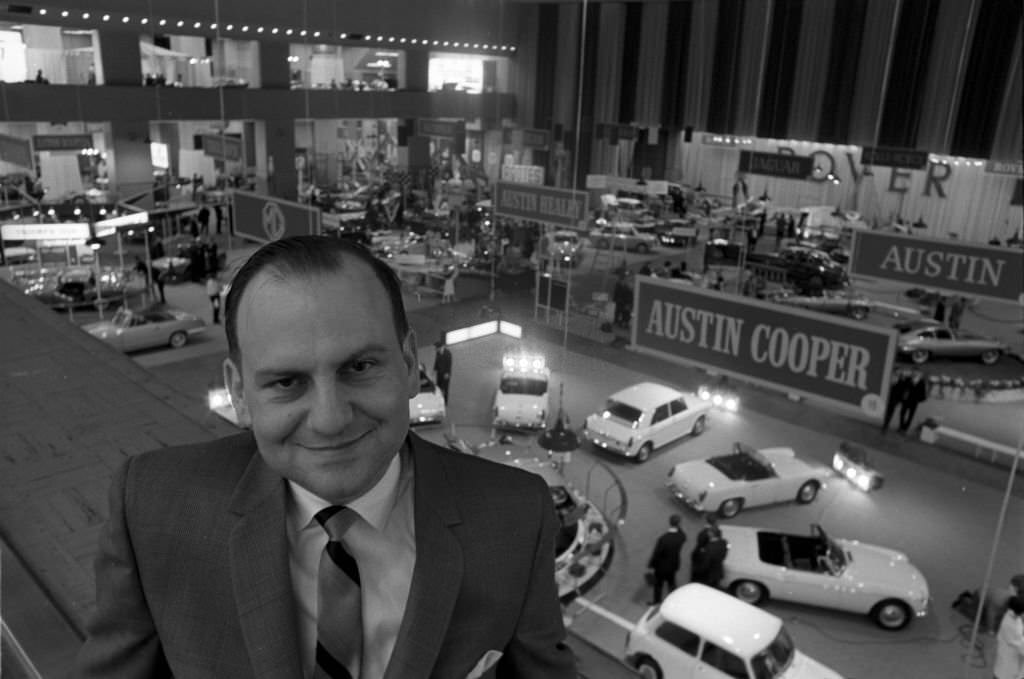 Lee Iacocca automobile executive, displaying a range of Fords at an auto show, New York, US, 1964.