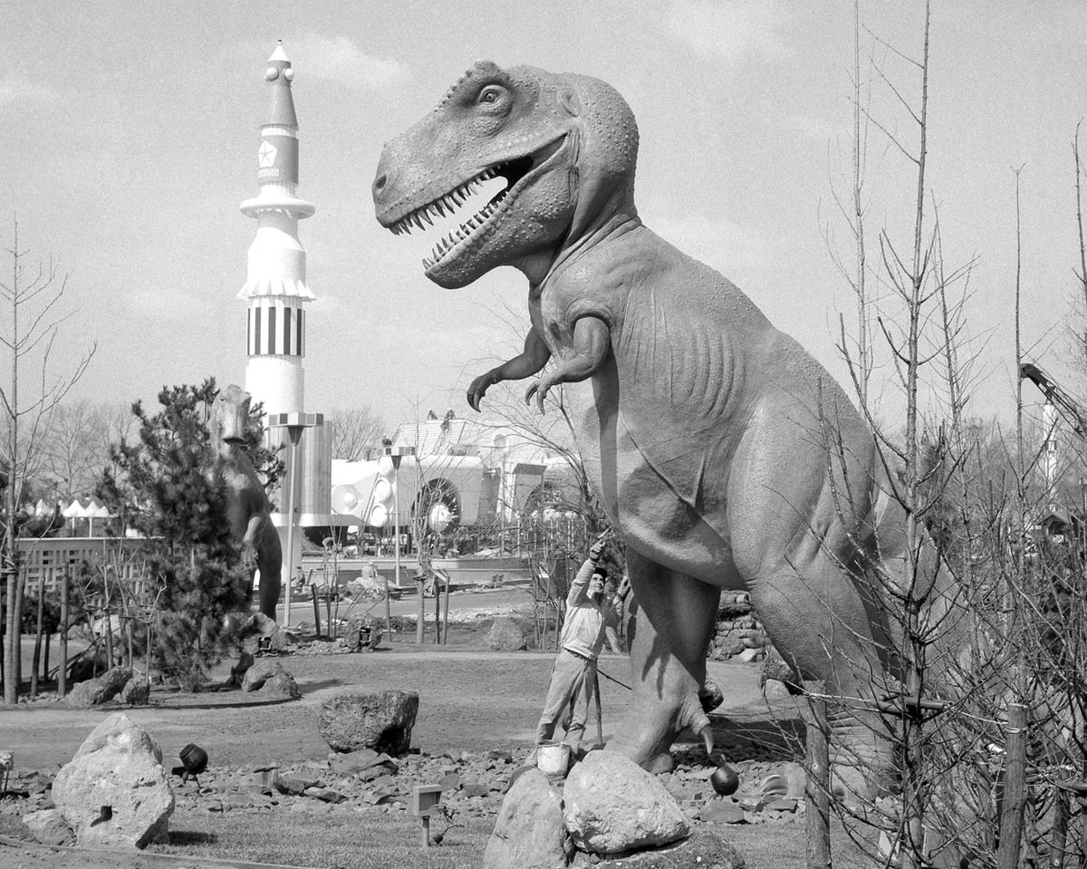 A prehistoric monster stands within sight of a 20th century rocket on April 9, 1964, symbolic of the pageant of world history presented by various exhibits at the New York World's Fair.