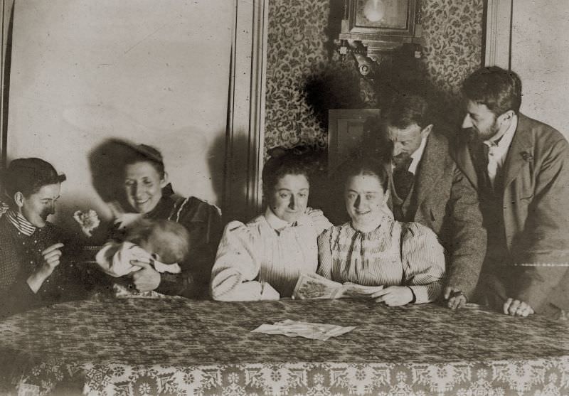 Family reading around the dining room table, circa 1900