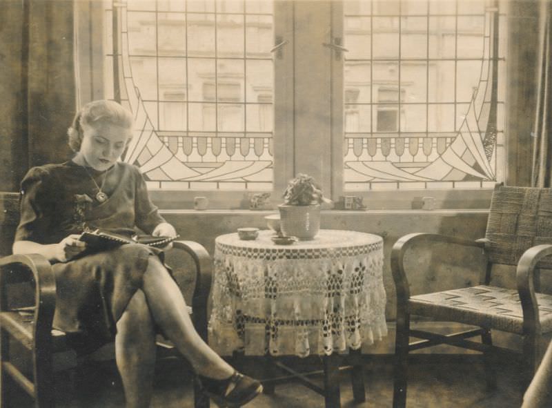 Beautiful woman reading while having tea, circa 1930s