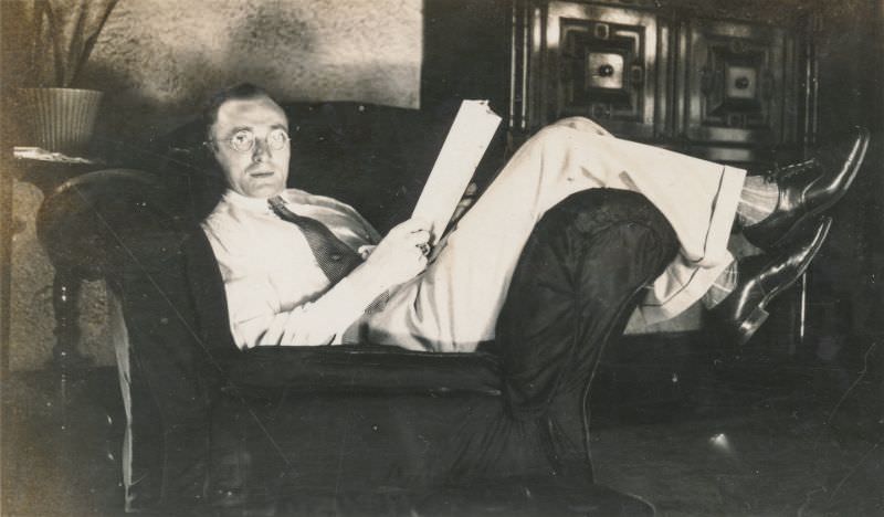 Man reads while laying on a chair, circa 1930s