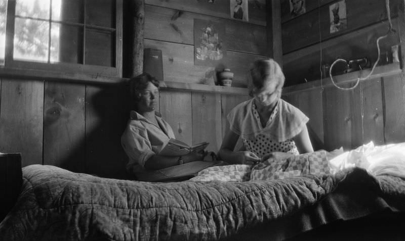 Two women inside a rustic cabin, circa 1930s