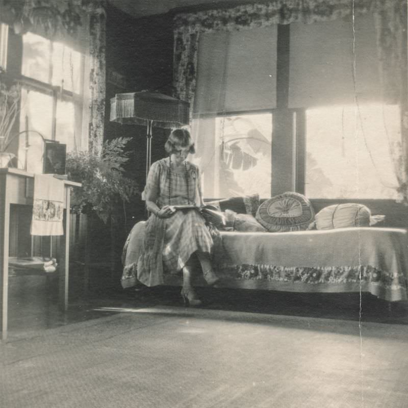 Woman reading in the sitting room, circa 1930s