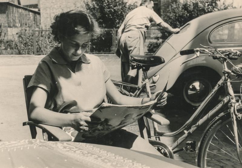 Woman reading a magazine outside, circa 1940s