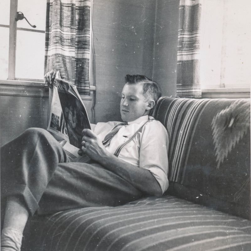 Young man reading The Saturday Evening Post, circa 1940s
