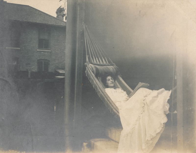 Woman rests in a large hammock, circa 1900s