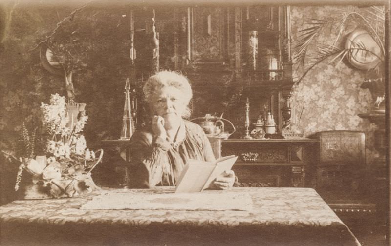 Elderly woman reading a book in her parlor