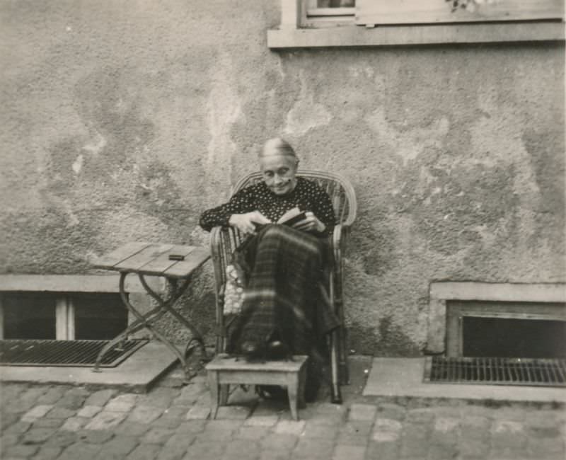 Elderly woman reading a book outside