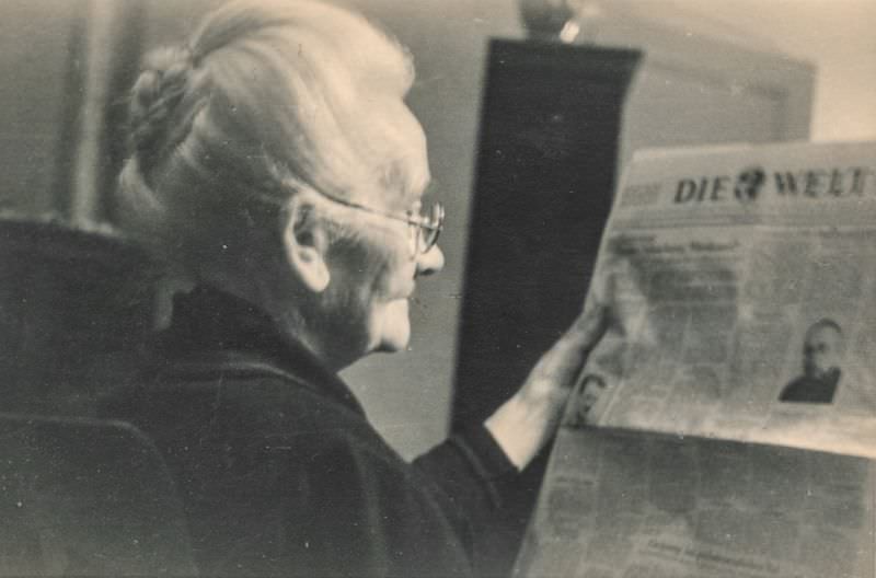 Elderly woman reading a newspaper