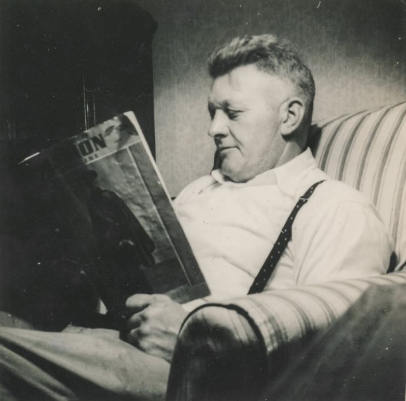 Man reading a magazine in his chair