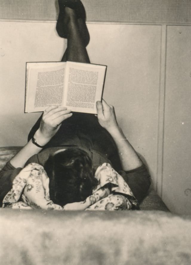 Woman reading a book in bed