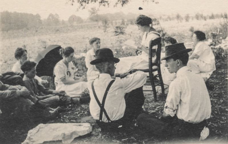 Group listening to a woman read aloud, circa 1910s