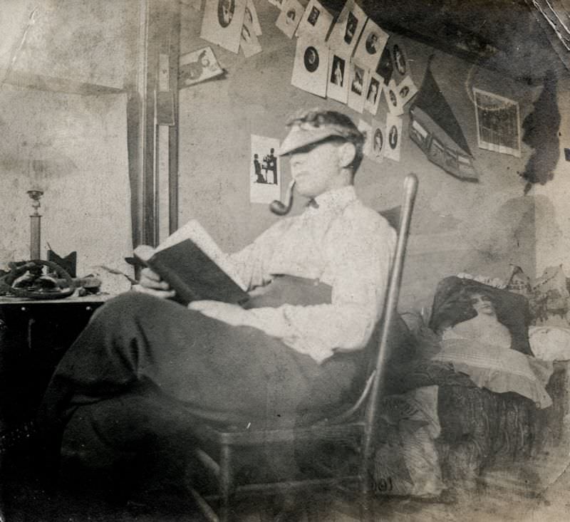 Man with a pipe reading a book, circa 1910s