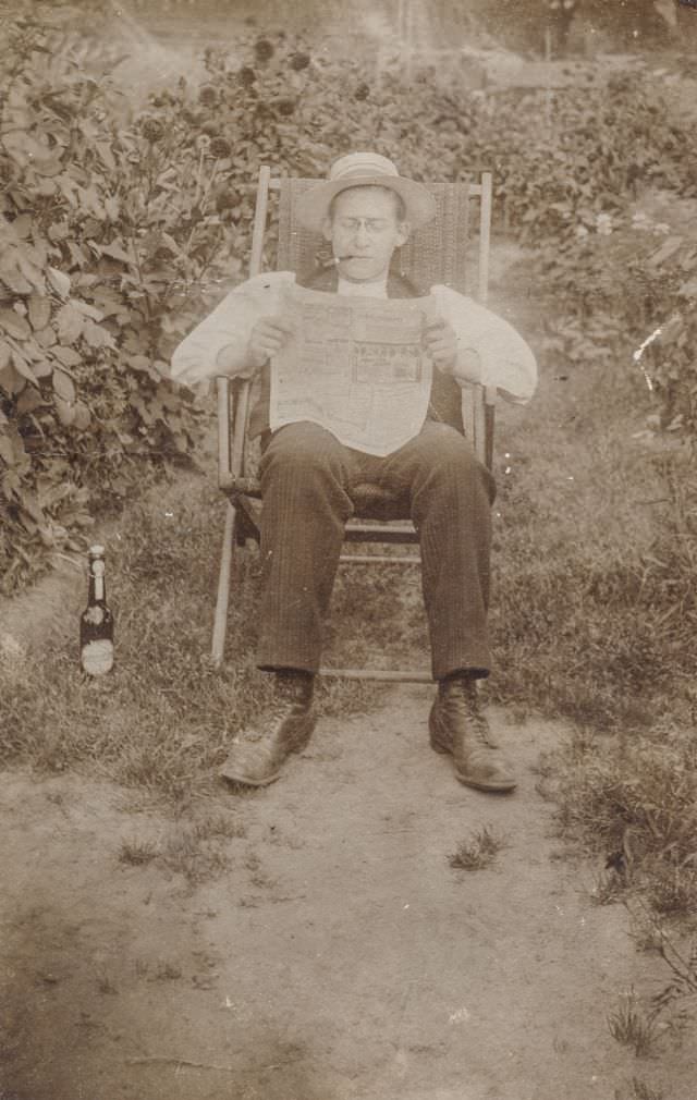 Man reading the newspaper outside, circa 1920s