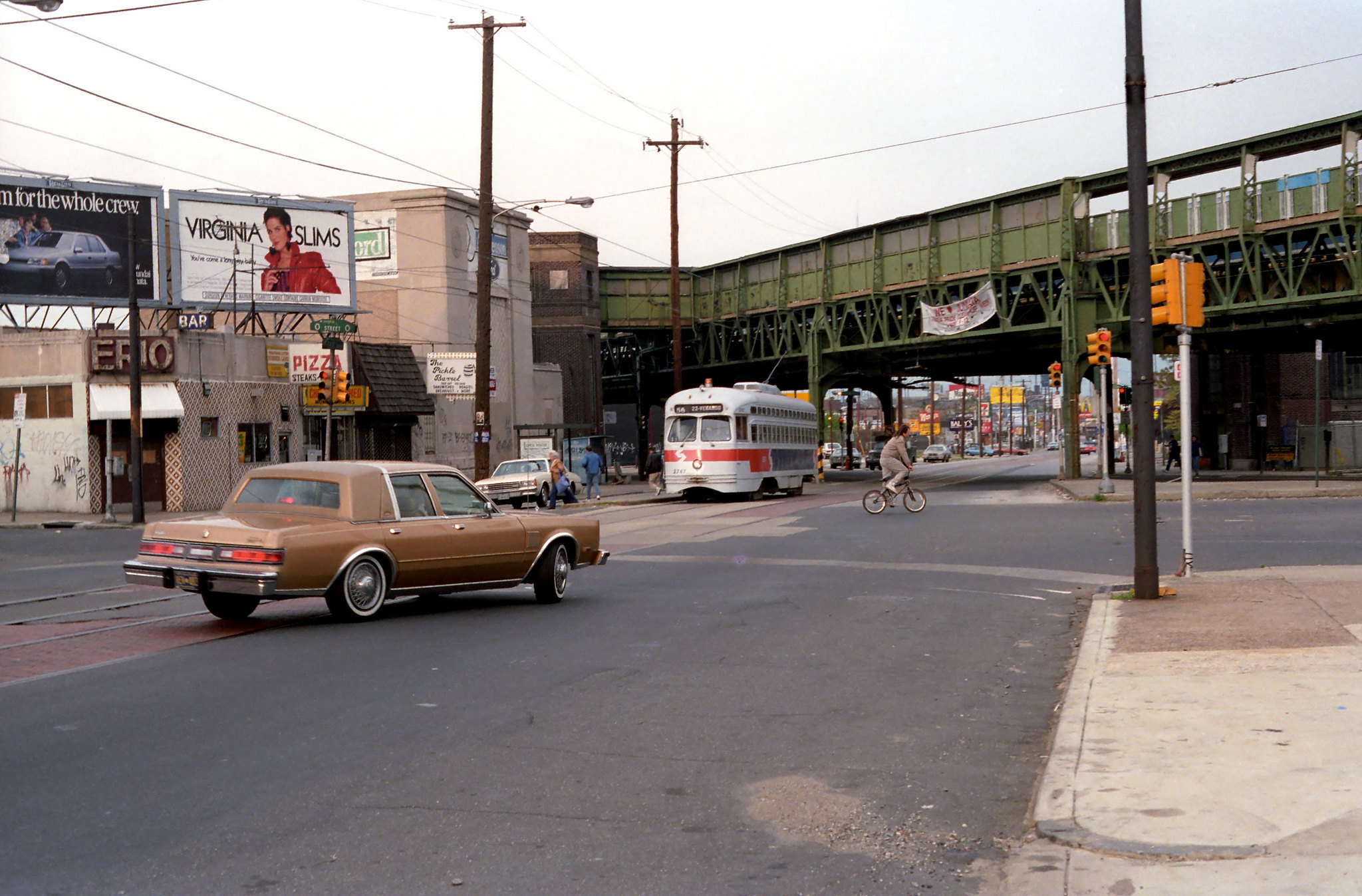 Septa Route 56 trolley service on Erie Ave. passing under the Frankford El, 1989