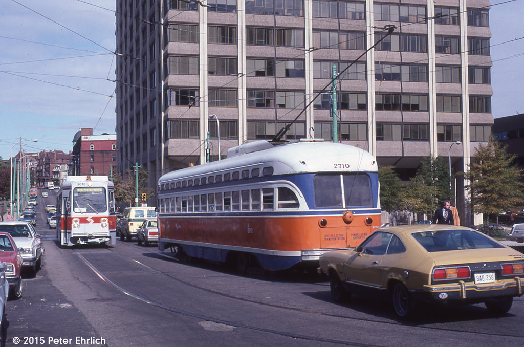 PCC 2710, outbound on Route 10, has just emerged from the subway, and is about to pass Kawasaki 9078, in training service.