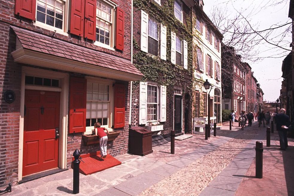 A young boy looks in the window a house (built in 1720) on Elfreth's Alley in the Old City neighborhood , Philadelphia, 1980.