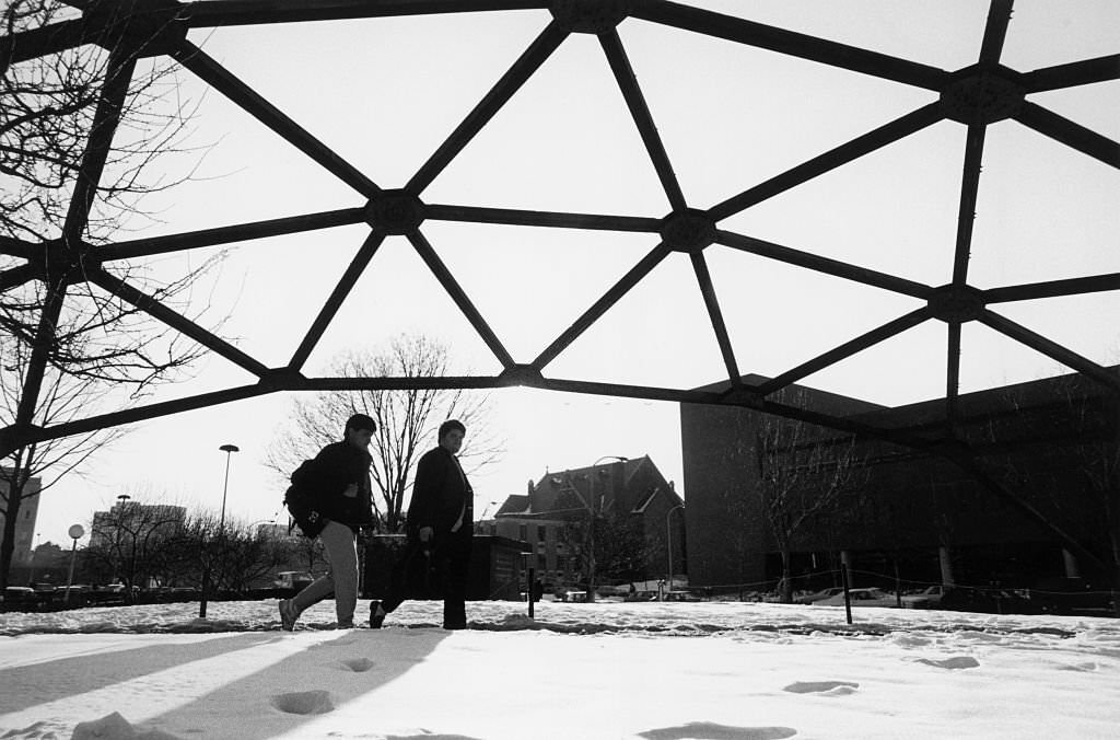 Two male students walk through the winter snow on the campus of Drexel University.