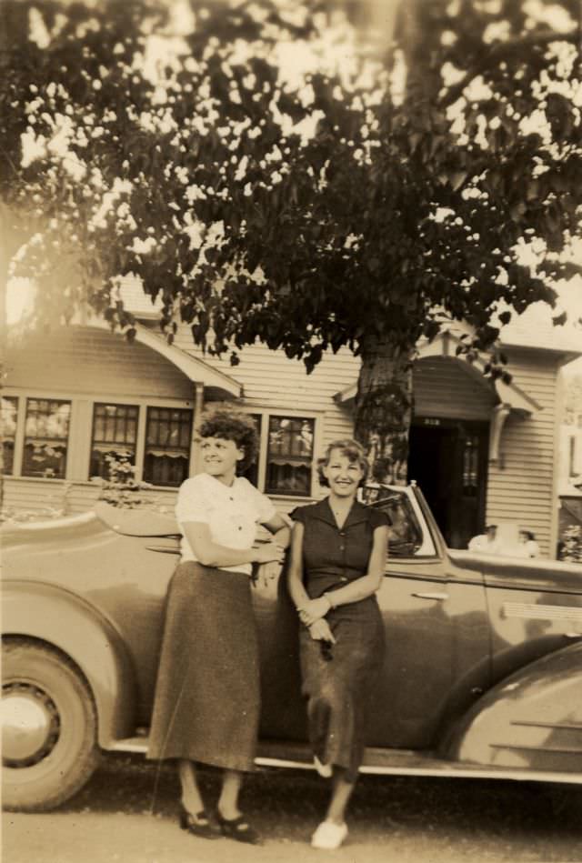 Two ladies posing with a 1935 Pontiac Convertible, 1938