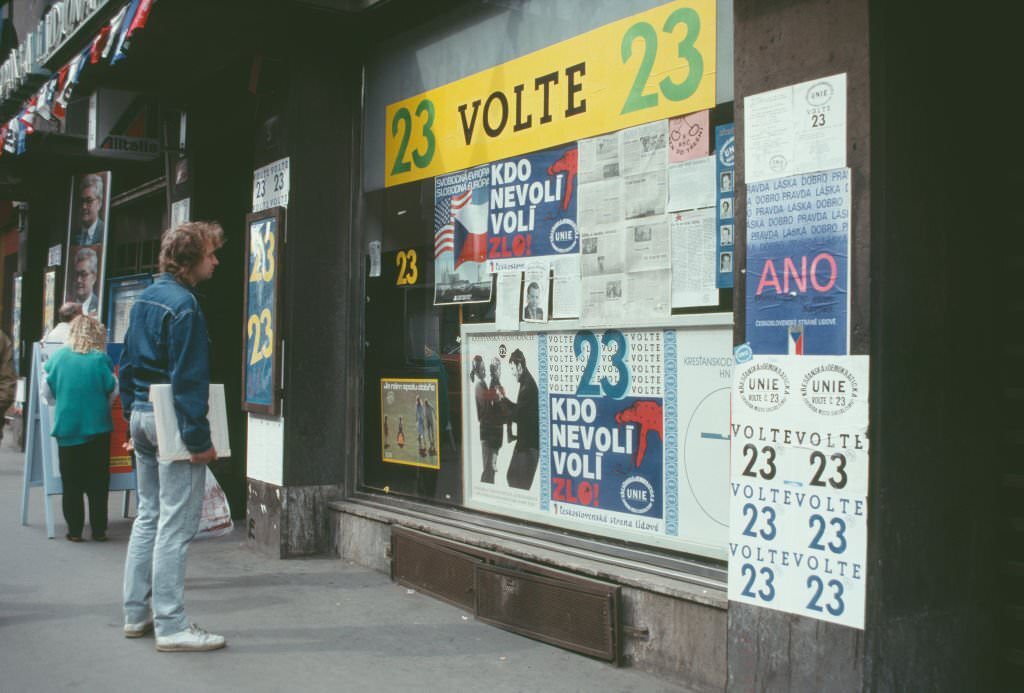 A man watches billboards for a political campaign, Prague, Czech Republic, June 1990.