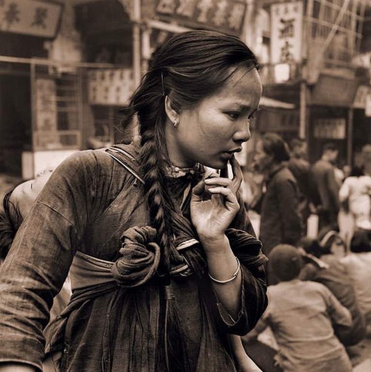 Young Mother Carrying a Child on her back in the market, Hong Kong Island, 1946