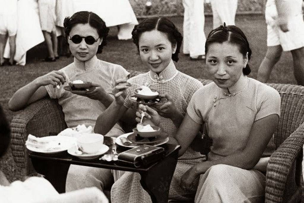 Three sisters awaiting the start of a tennis match. Corbis.