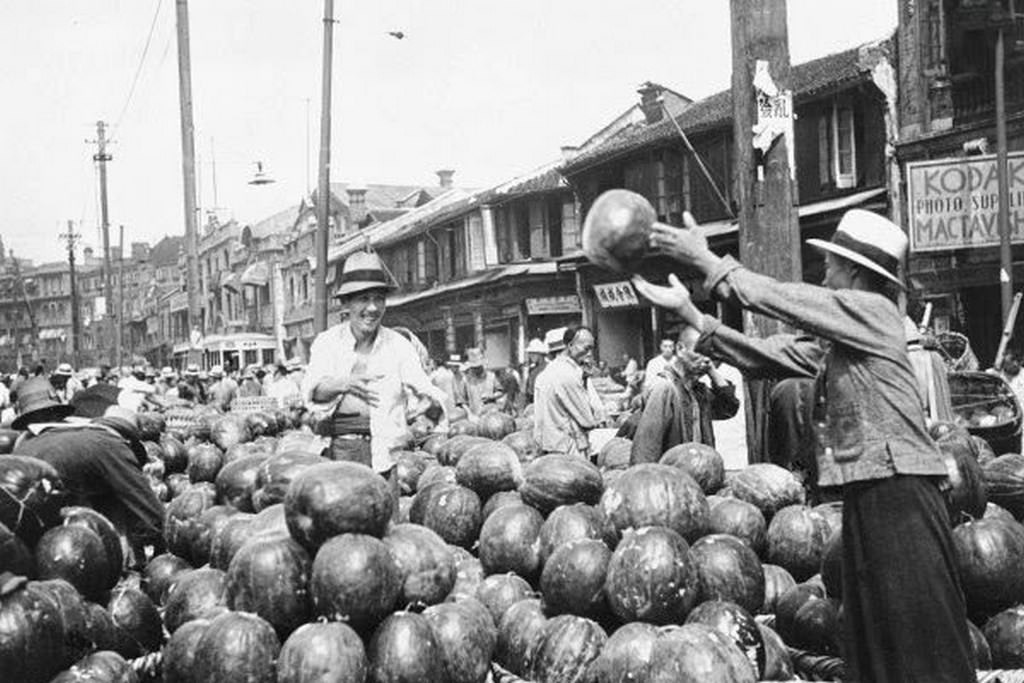 Chinese laborers on the docks unloading watermelons to be sold, 1936