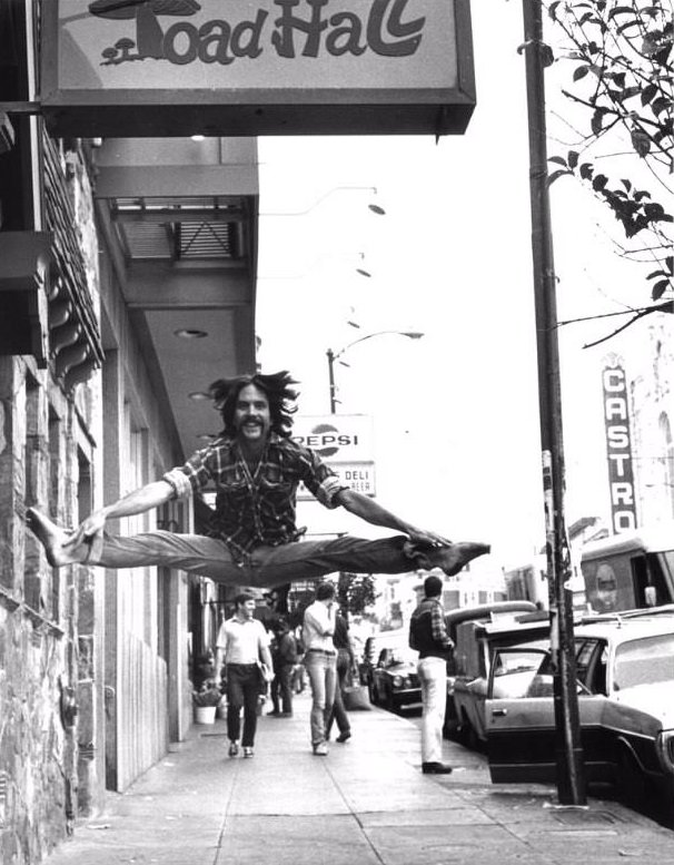 Man leaping in front of Toad Hall, Castro Street, San Francisco, 1978