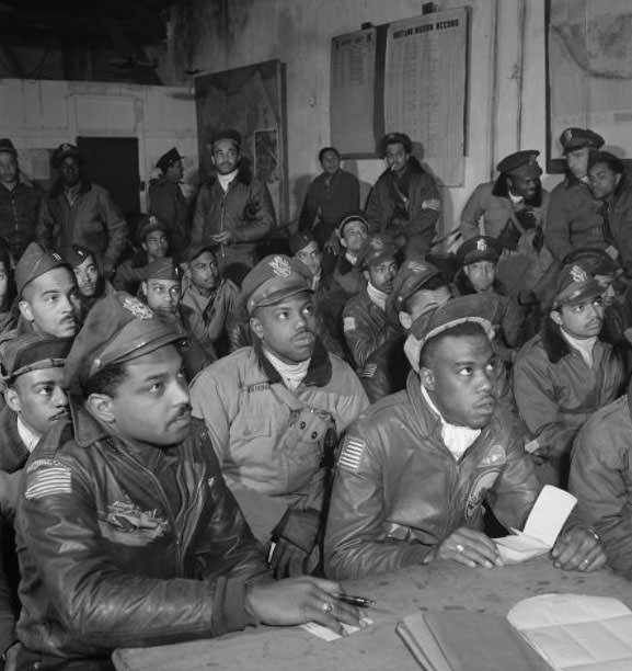 Several Tuskegee airmen attending a briefing in Ramitelli, Italy, March 1945