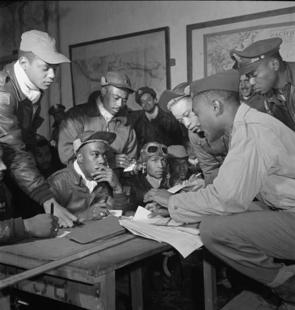 Several Tuskegee airmen attending a briefing