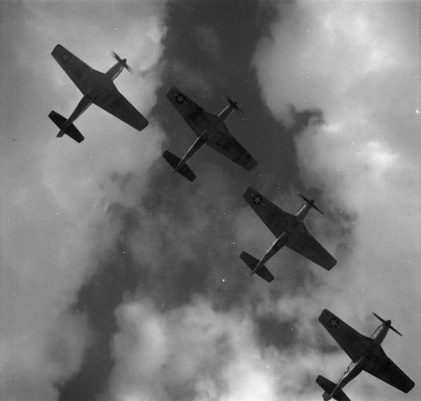 Four P-51 Mustangs flying in formation