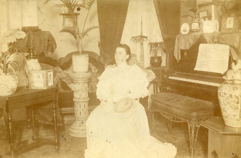 Woman seated by piano