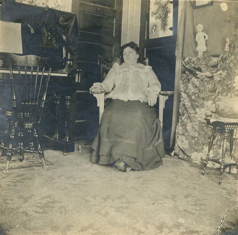 Woman seated in corner of room