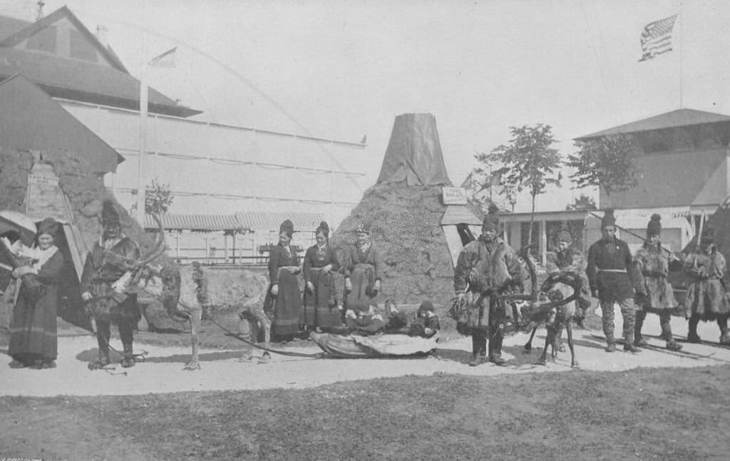 An interior view of the Lapland Village at the Midway Plaisance, showing natives and reindeer during the World's Columbian Exposition in Chicago, 1893.