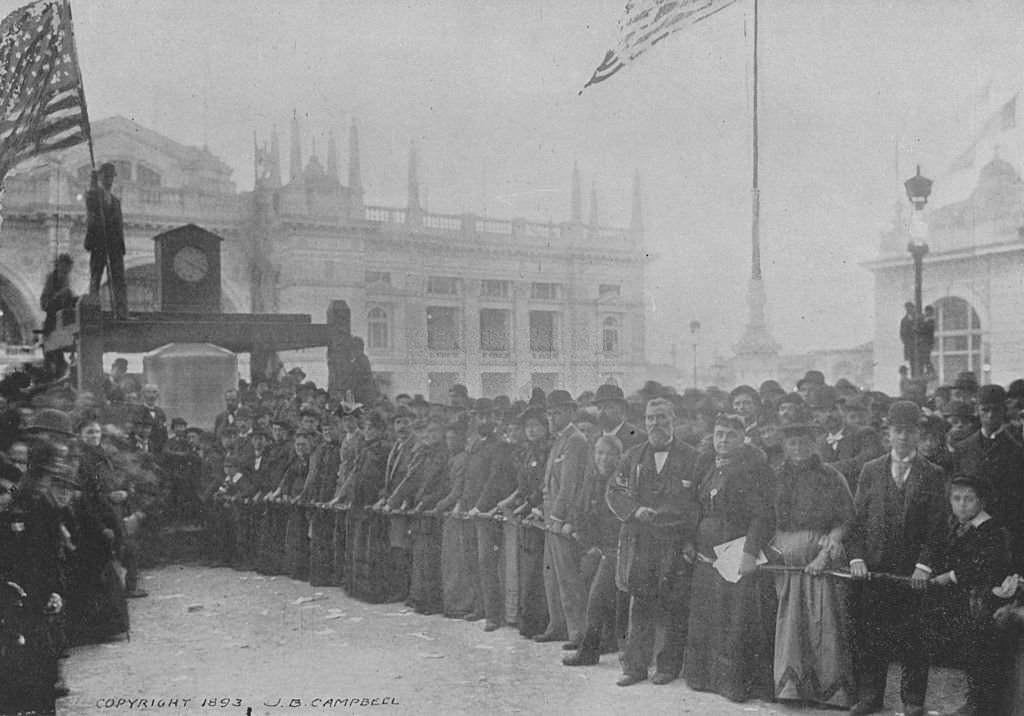 Representatives of the different nations ringing the new Liberty Bell at the World's Columbian Exposition in Chicago, Illinois, 1893.