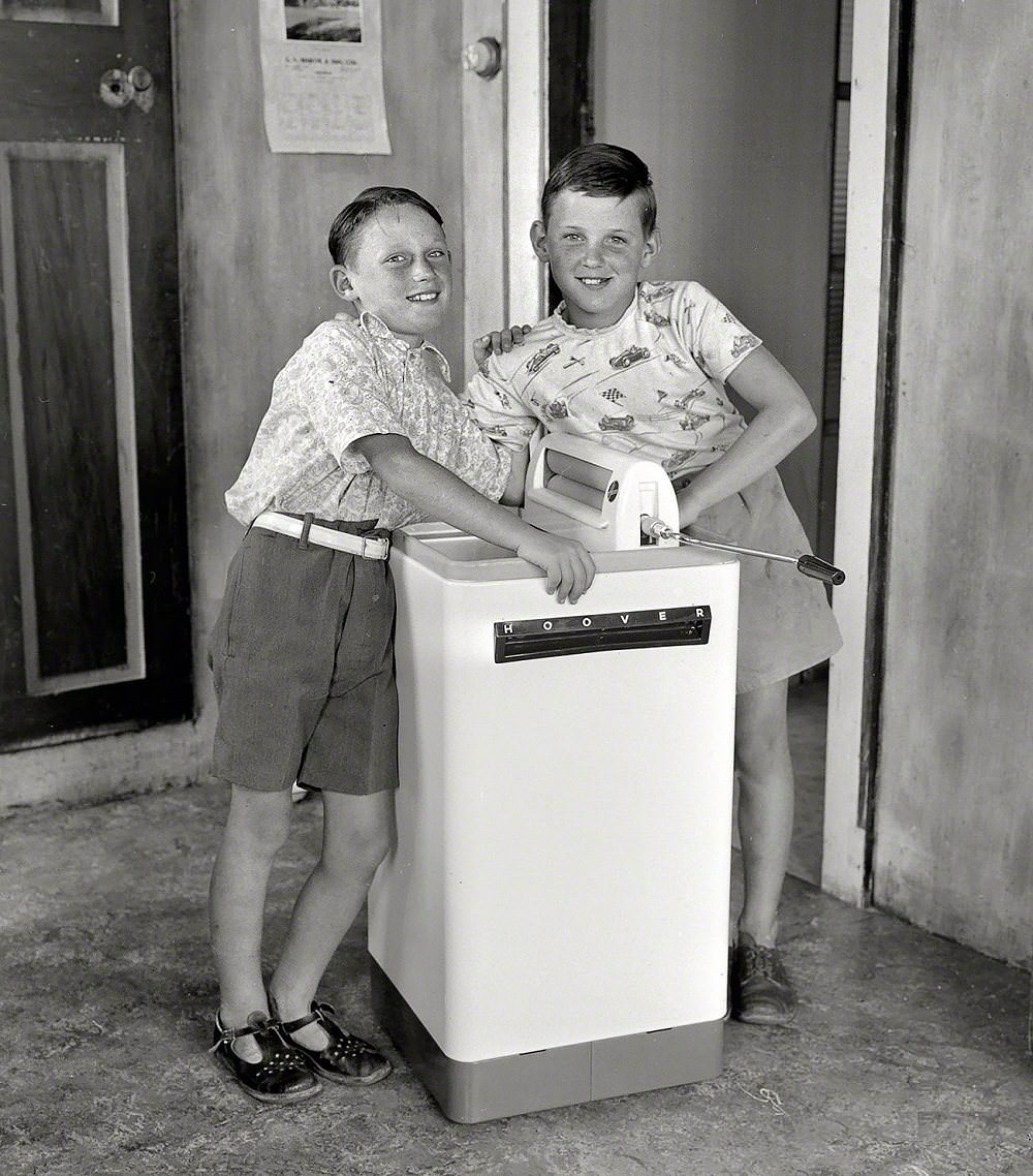 Anthony and Paul Banks with a Hoover washing machine, Wellington, New Zealand, 1956