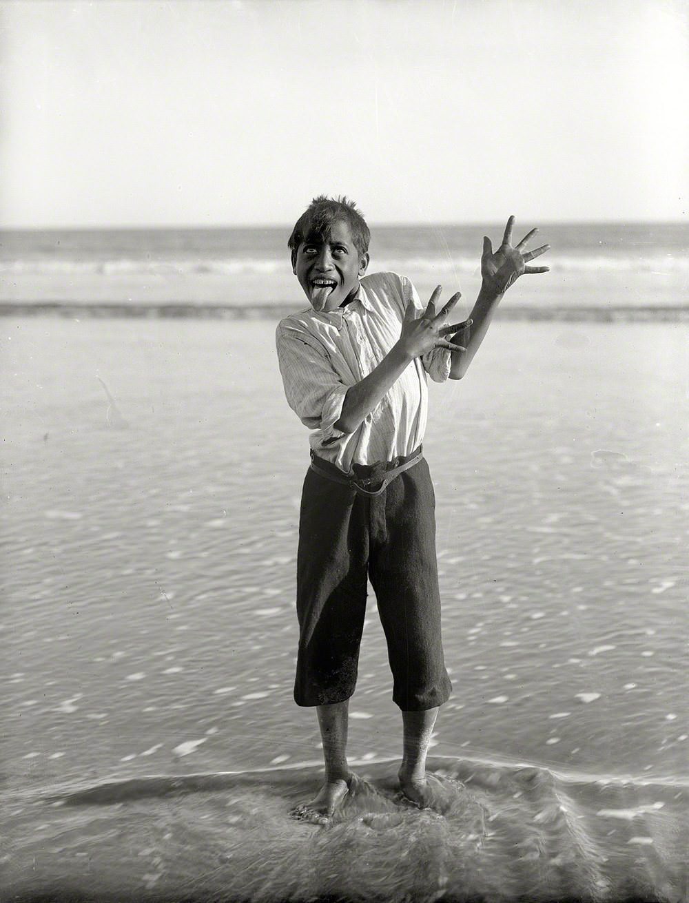 Maori boy performing a haka on the beach, Northland, New Zealand, 1913