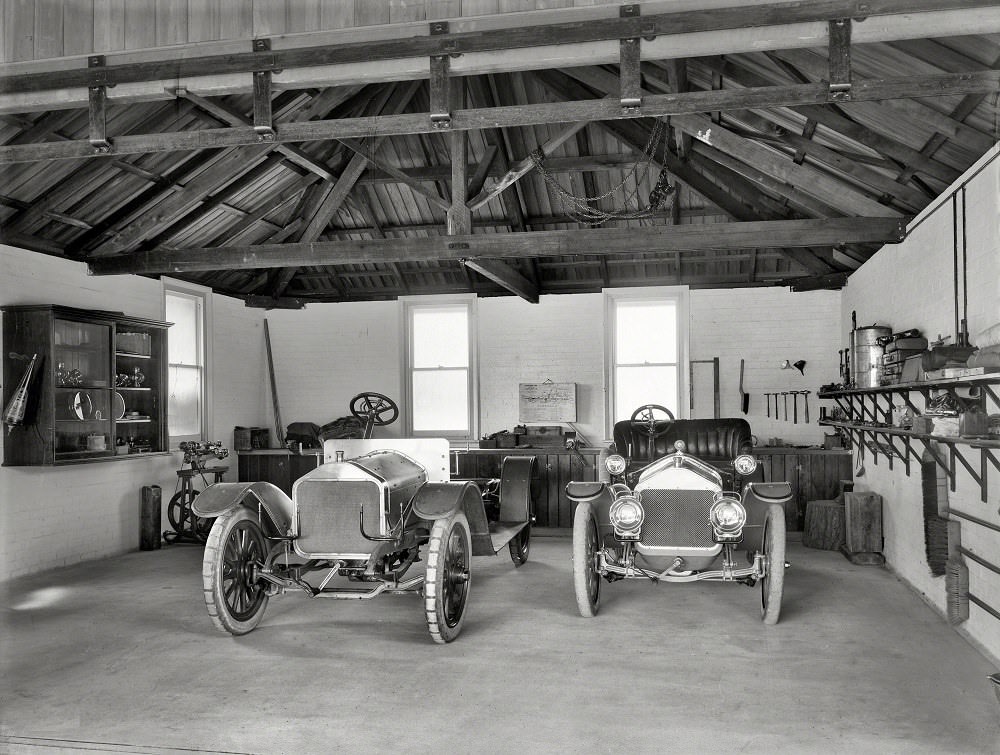 Wolseley and Cadillac motor cars in garage, Christchurch, New Zealand, circa 1908