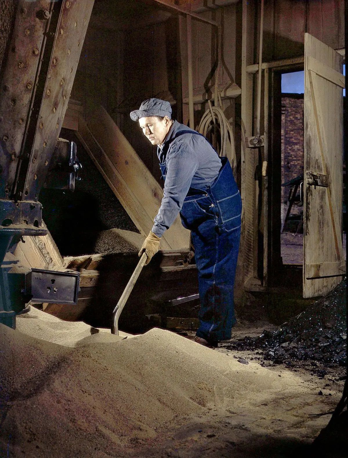 Mrs. Thelma Cuvage sifts and cleans sand for use in locomotives.