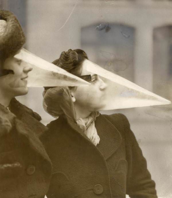 Women wear plastic headgear intended to protect themselves from snowstorms in Montreal, 1939.