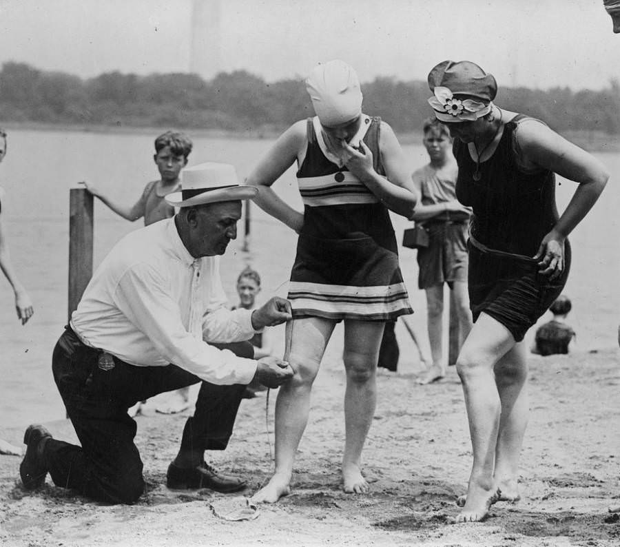 Beach policeman Bill Norton measures the distance between a woman's knee and the bottom of her swimsuit to be sure that it's not too large — in keeping with rules of the time — in Washington, D.C., 1922.