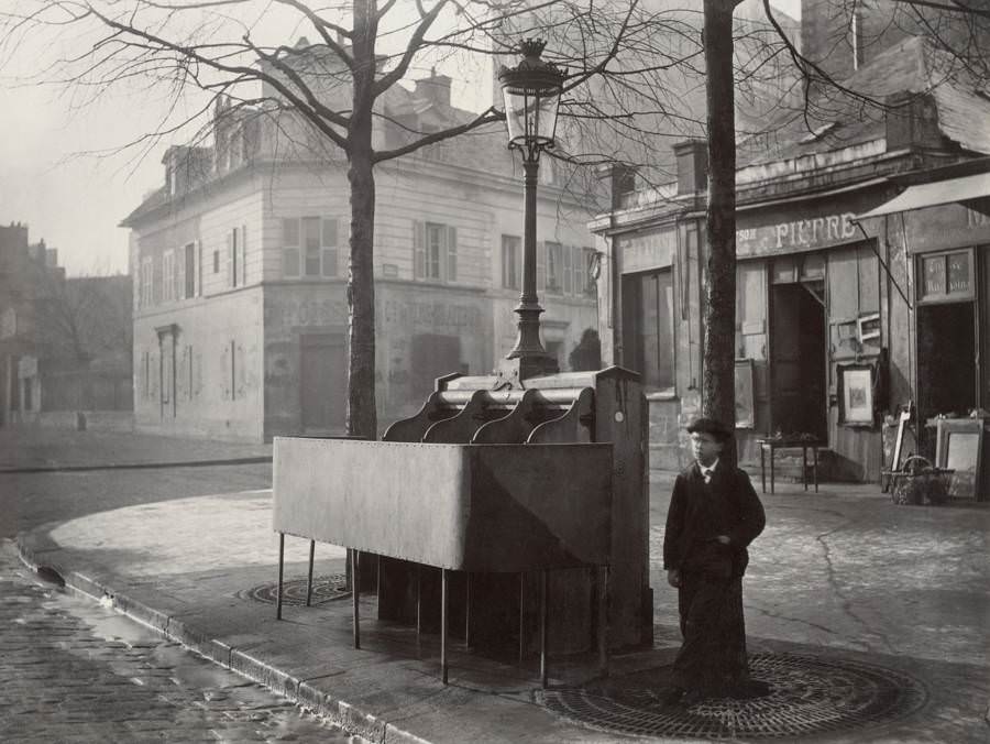 A boy stands near a pissoir, one of the many outdoor urinals installed on the streets of Paris starting in the mid-19th century. At their peak, Paris' pissoirs numbered more than 1,000.