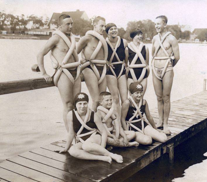 German youths wear bike tires repurposed as swimming aids, 1925.