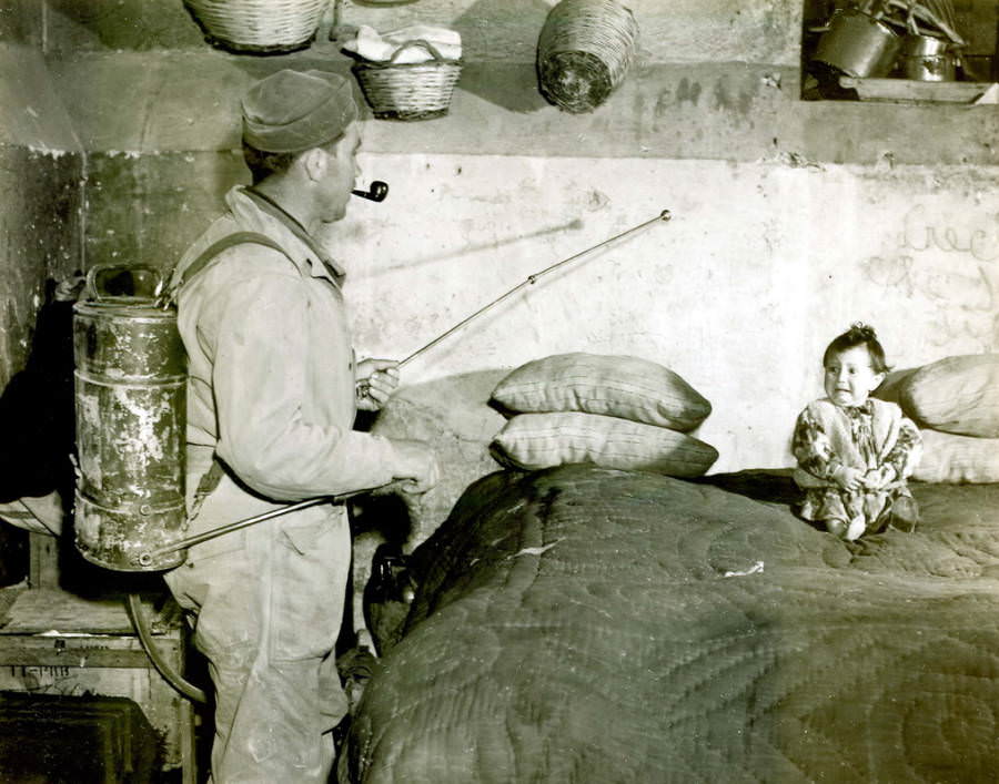 A soldier sprays the interior of an Italian house with a mixture of DDT and kerosene in order to control malaria during World War II, circa 1945.