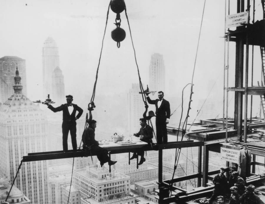 Waiters serve lunch to two steel workers on a girder high above New York City on November 14, 1930, during construction of the famed Waldorf-Astoria Hotel.