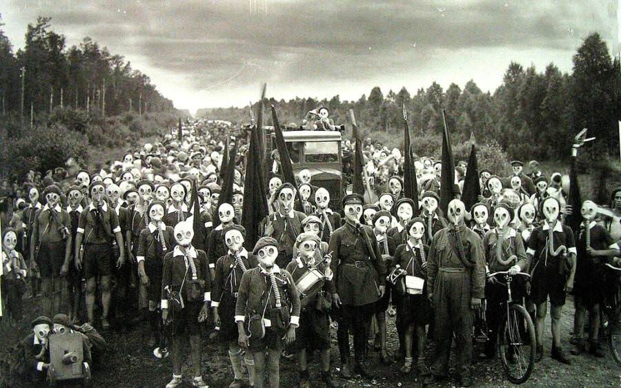 Members of the Young Pioneers, a Soviet government youth group, don gas masks as part of an attack preparation drill in the Leningrad area in 1937.