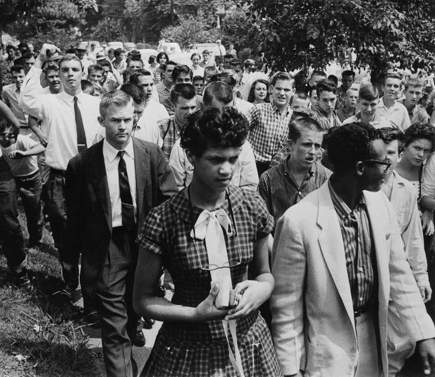 Counts is escorted from school, followed by a crowd of 100 jeering students.